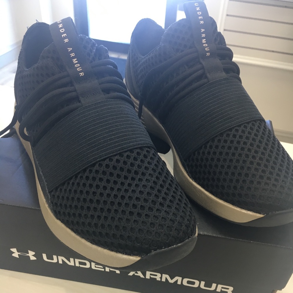 Women’s black Under Armour sneakers.
